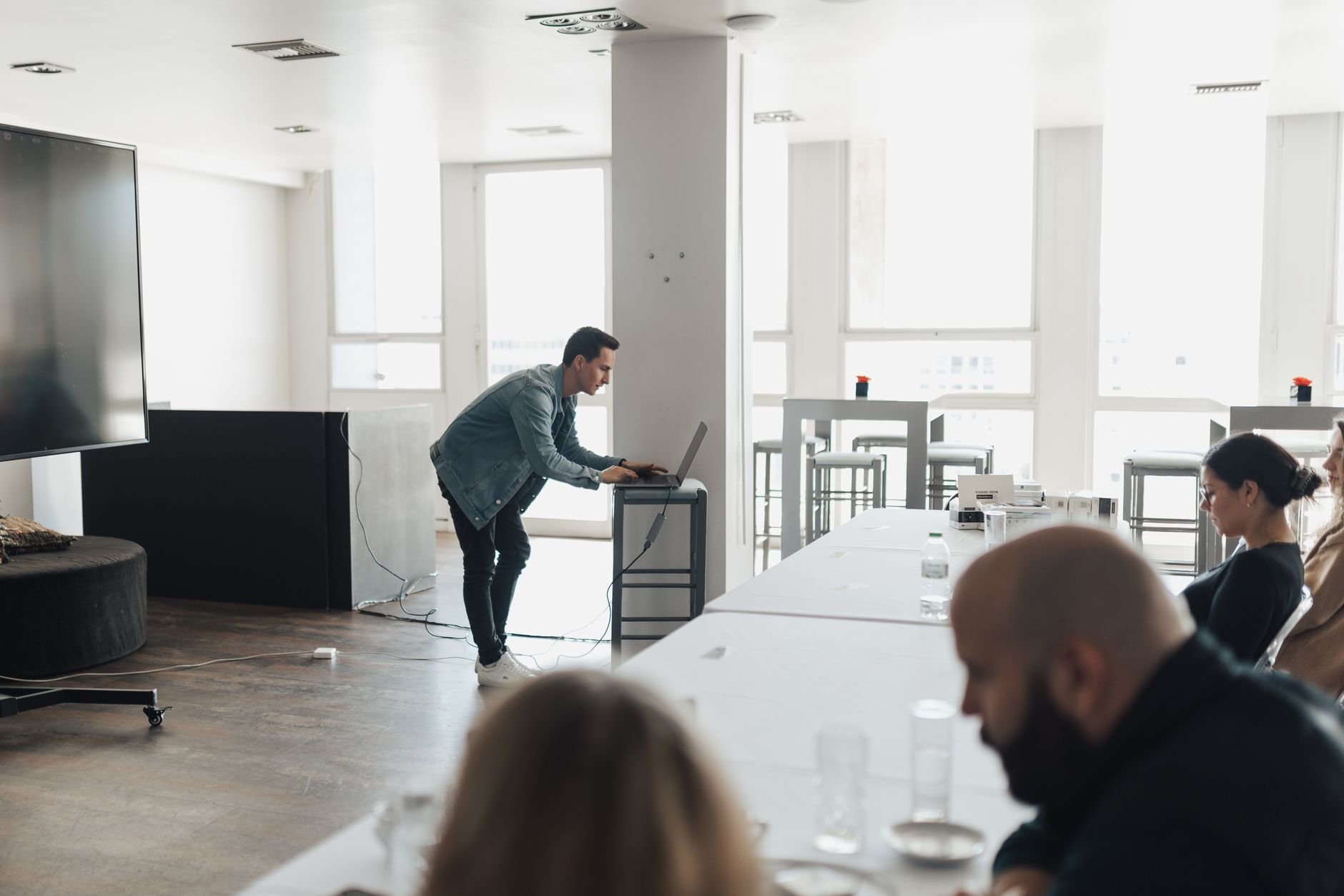 Professional presenting AI training to a team in a modern office